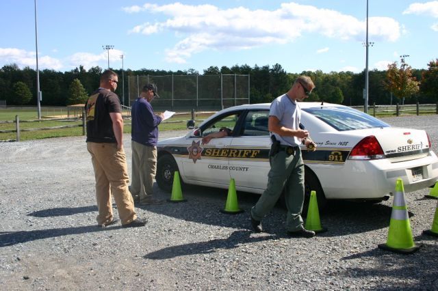 At a vehicle rodeo competition held during Charles County's annual Health and Wellness Fair, judges assess a CCSO officer's parking skills. Three CCSO officers earned top spots in the competition, which promotes safe driving.